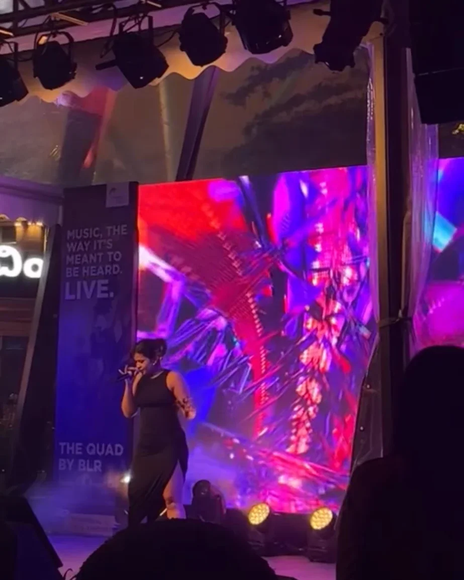 Ira singing live on stage at The Quad